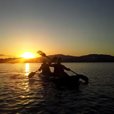 two people in a boat on the water at sunset at Jungle Tent 3x3, Latino Glamping & Tours, Paquera in Paquera