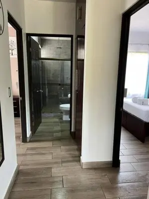 a bathroom with a shower and a toilet and a sink at Encantadora Casa Amapolas in Cóbano
