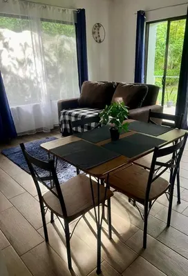 a living room with a table and a couch at Encantadora Casa Amapolas in Cóbano