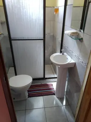 a small bathroom with a toilet and a sink at Hotel La Puesta Del Sol B&B in Monteverde Costa Rica