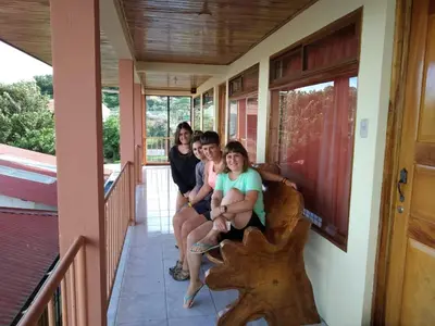 a group of girls sitting on the side of a house at Hotel La Puesta Del Sol B&B in Monteverde Costa Rica