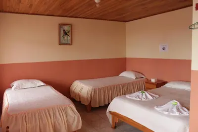 a room with two beds in a room at Hotel La Puesta Del Sol B&B in Monteverde Costa Rica