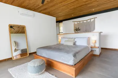 a bedroom with a large bed and a mirror at Casa Mirame in Carmen