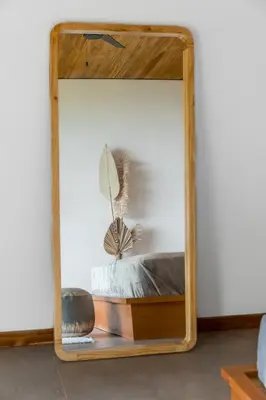 a mirror with a wooden frame in a room at Casa Mirame in Carmen