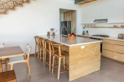 a kitchen with a large island with bar stools at Casa Mirame in Carmen