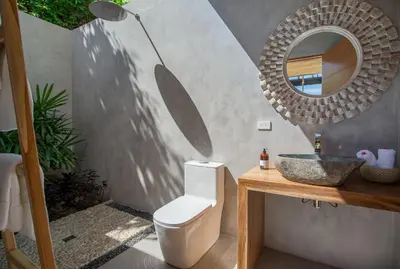 a bathroom with a white toilet and a mirror at Casa Mirame in Carmen