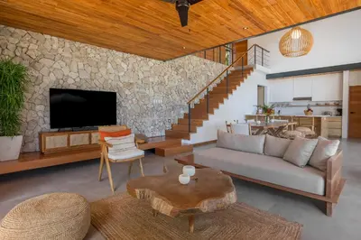a living room with a couch and a tv and a table at Casa Mirame in Carmen