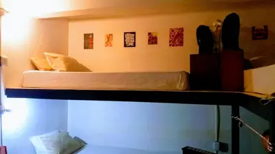 a bunk bed on top of a room at Casajungla Hostel in Jacó