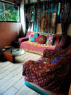 a living room with a couch and a table at Casajungla Hostel in Jacó