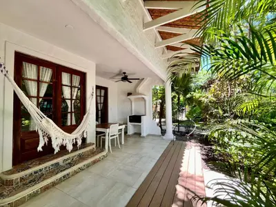 a porch with a hammock in a house at Hotel El Manglar y Cantarana in Playa Grande