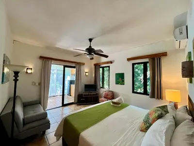 a bedroom with a bed and a ceiling fan at Hotel El Manglar y Cantarana in Playa Grande
