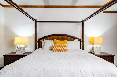 a bedroom with a large bed with two lamps at La Esquina (3 minutes from Beach, perfect for a family getaway) in Tamarindo