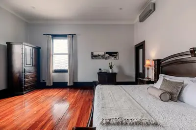 a bedroom with a large bed and a wooden floor at Hotel Majestad in San José