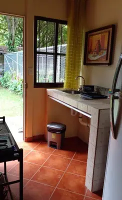 a kitchen with a sink and a window at Casita El Sonido de las Aves in Uvita