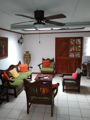 a living room with couches and a ceiling fan at Confortable y privado estudio en zona exclusiva . in San José