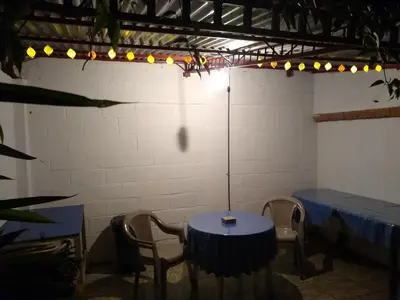 a room with a table and chairs and lights at Confortable y privado estudio en zona exclusiva . in San José