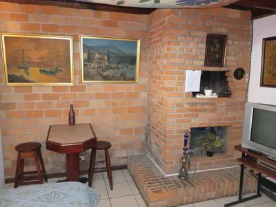 a living room with a brick wall with a fireplace at Confortable y privado estudio en zona exclusiva . in San José