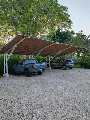 a garage with two cars parked under a roof at Adeluna Luxury Villas in Montezuma