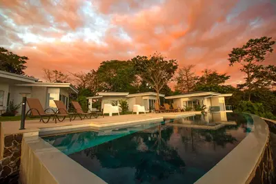 a swimming pool in front of a house at Adeluna Luxury Villas in Montezuma