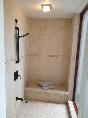 a bathroom with a shower with a shower at Palmetto Lodge in Playa San Miguel