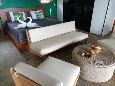 a room with a bed with two swans on it at Palmetto Lodge in Playa San Miguel