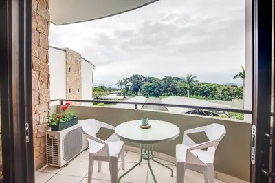 a balcony with a table and chairs and a view at CR MARIPOSA RENTALS Cozy Retreat with Pool,Tennis,Gym,Free WiFi in Santa Ana