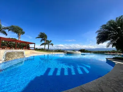 a swimming pool with blue water and palm trees at CR MARIPOSA RENTALS Cozy Retreat with Pool,Tennis,Gym,Free WiFi in Santa Ana