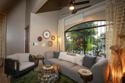 a living room with a couch and a window at Villa Palmeras with jungle views pool near MA in Quepos
