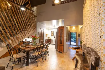 a dining room with a table and chairs at Villa Palmeras with jungle views pool near MA in Quepos