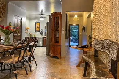 a dining room and kitchen with a table and chairs at Villa Palmeras with jungle views pool near MA in Quepos