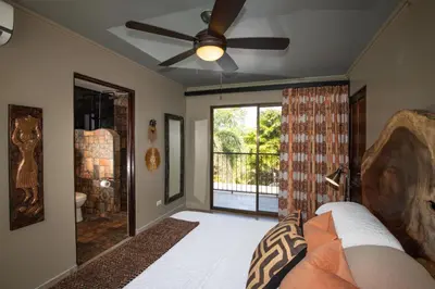 a living room with a ceiling fan and a window at Villa Palmeras with jungle views pool near MA in Quepos