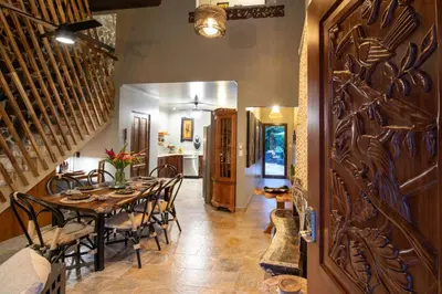 a dining room with a table and chairs at Villa Palmeras with jungle views pool near MA in Quepos