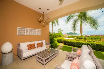 a living room with a couch and a table at Miramar 4E 3 bdr Ocean View in Los Suenos in Herradura
