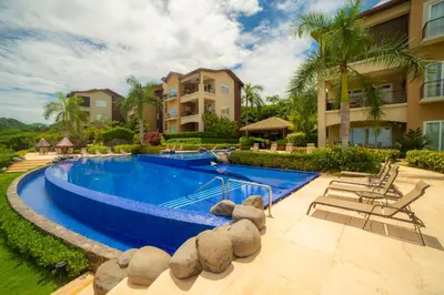 an image of a swimming pool at a villa at Miramar 4E 3 bdr Ocean View in Los Suenos in Herradura
