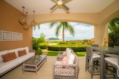 a living room with a couch and a table at Miramar 4E 3 bdr Ocean View in Los Suenos in Herradura