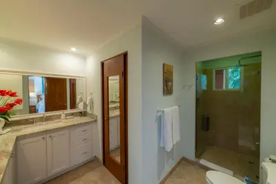 a bathroom with a shower and a sink and a toilet at Veranda 3B 2 bdr Garden View in Los Suenos in Herradura