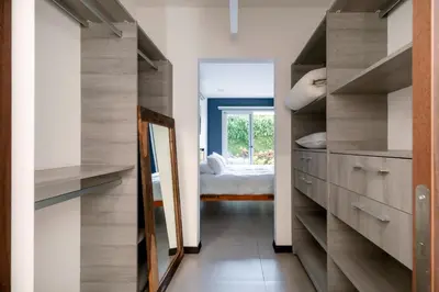 a room with a mirror and a bedroom with a bed at Urban Flats Studios by Corporate Stays in San José