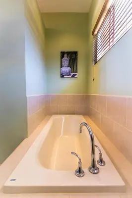 a large white bath tub in a bathroom with a window at Cabo Velas Estates in Playa Grande