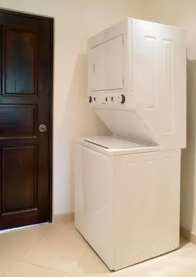 a white kitchen with a microwave and a refrigerator at Cabo Velas Estates in Playa Grande