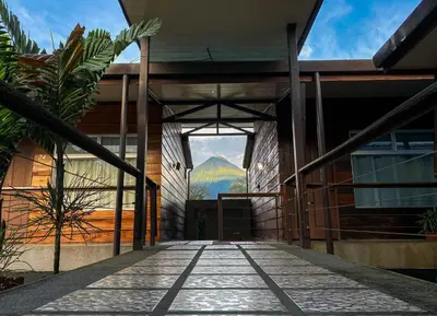 a building with a view of a mountain through a doorway at Hotel Arenal Rabfer in Fortuna