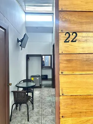 a room with a table and a table and a door at Hotel Arenal Rabfer in Fortuna