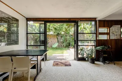 a dining room with a table and a large sliding glass door at Casa Mundo in San José