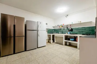a kitchen with stainless steel refrigerators and a counter at Casa Mundo in San José