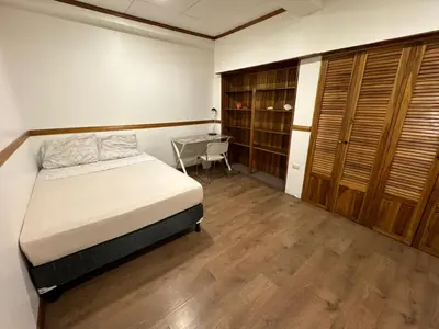 a bedroom with a bed and a desk in it at Casa Mundo in San José