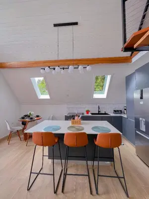 a kitchen with a table and chairs in a room at Amalú Luxury View Cabins in Monteverde Costa Rica