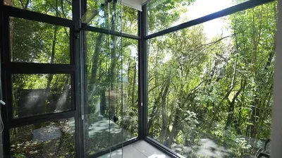 an open window with a view of a forest at Amalú Luxury View Cabins in Monteverde Costa Rica