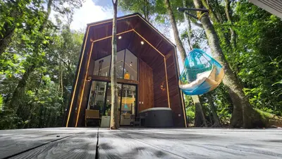 a small wooden house in the middle of a forest at Amalú Luxury View Cabins in Monteverde Costa Rica