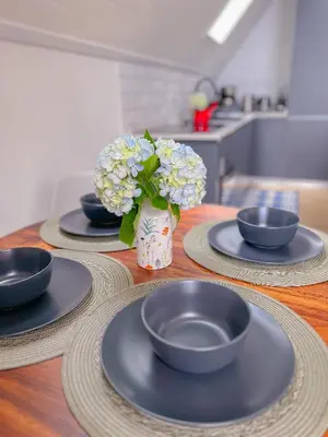 a table with three plates and a vase of flowers at Amalú Luxury View Cabins in Monteverde Costa Rica
