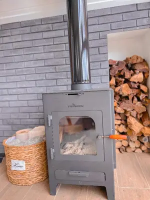 a woodburning oven with a pile of fire wood at Amalú Luxury View Cabins in Monteverde Costa Rica