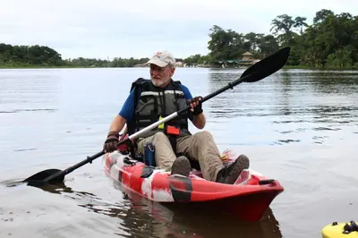a man in a kayak on the water at Casa Chilamates 2.0 in Tortuguero
